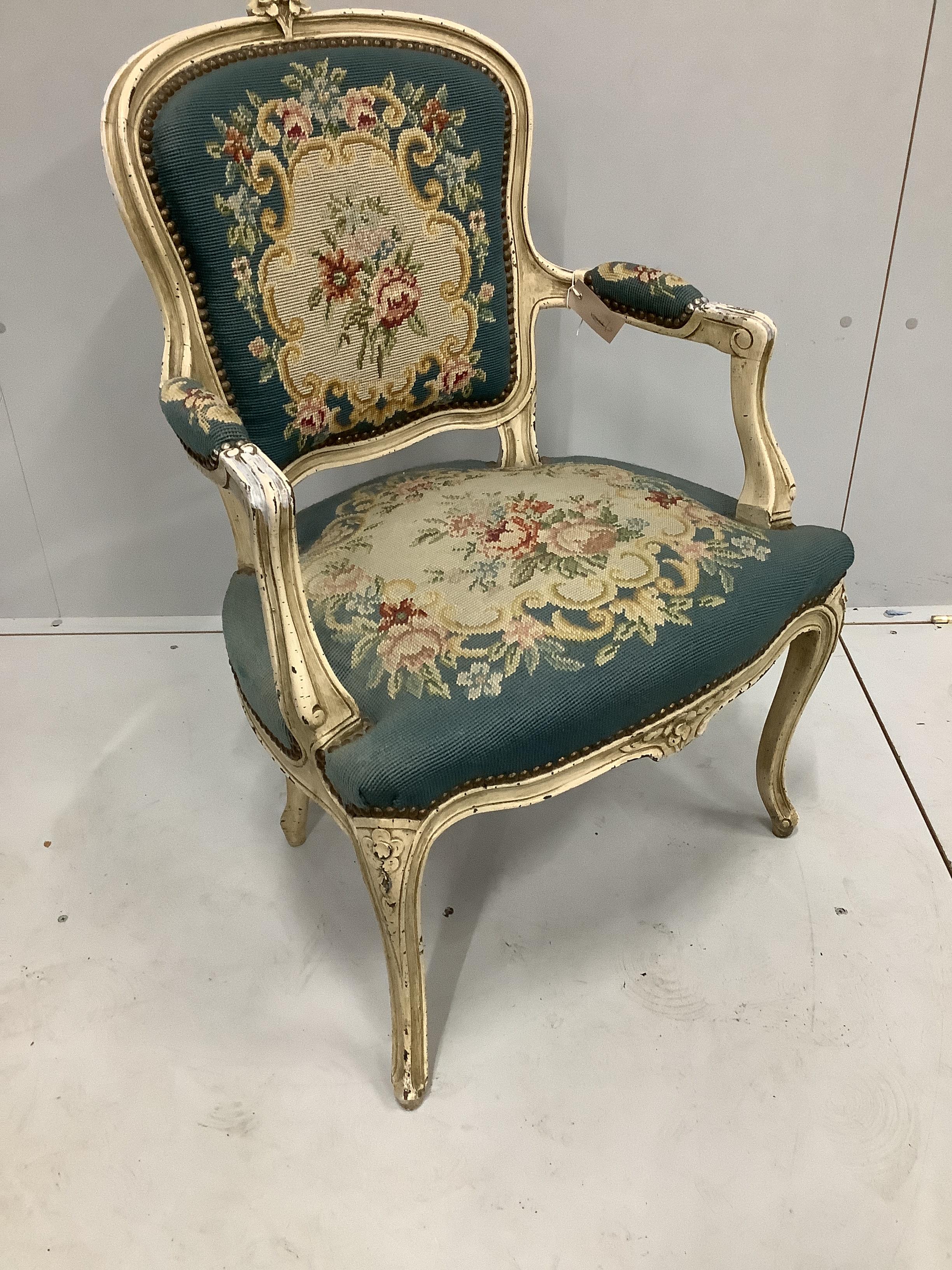 A Louis XVI style painted fauteuil with floral needlework upholstery, width 56cm, depth 50cm, height 88cm